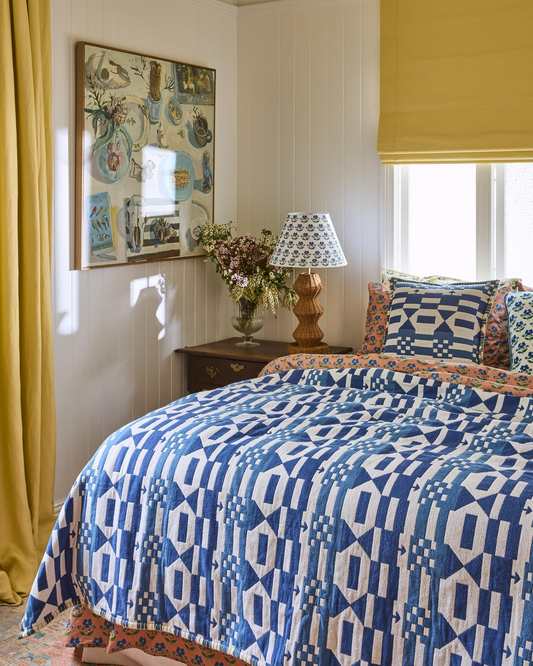 blue geometric cotton throw with blanket-stitch edging