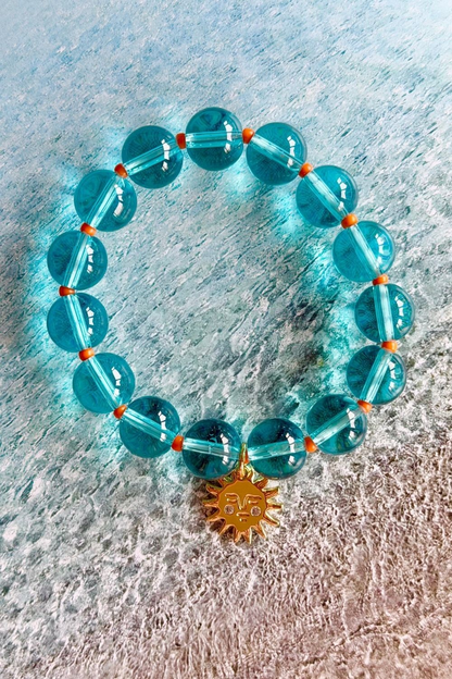 Aqua glass bead bracelet with gold sun pendant